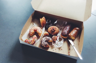Half eaten box of office doughnuts